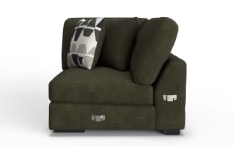 Dark olive green fabric corner sofa section with textured upholstery, loose back cushions, a geometric patterned throw pillow, and metal corner connectors.