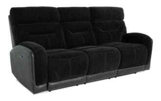 Black three-seat reclining sofa with plush fabric cushions and padded armrests, featuring leather trim base for modern living room comfort.