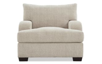 Beige Cypress Transitional Chair with plush polyester fabric upholstery, cozy Bob-O-Pedic® Memory Foam, and cushioned pillow for living room comfort.