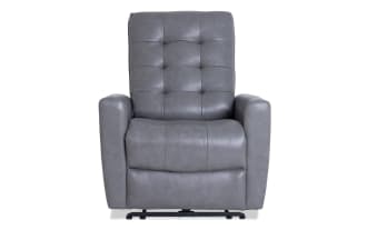 Gray leather recliner chair with tufted backrest, padded armrests, and cushioned seat, designed for comfort and relaxation.