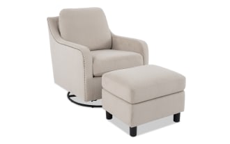 Beige upholstered armchair with matching ottoman, featuring a modern design, soft fabric, and black wooden legs for living room seating.
