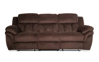 Brown plush fabric reclining sofa with padded armrests and segmented cushioned backrest, designed for living room comfort and style.