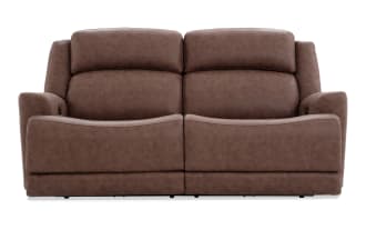 Brown leather reclining loveseat with plush cushioning, padded armrests, and a modern design suitable for living room seating.