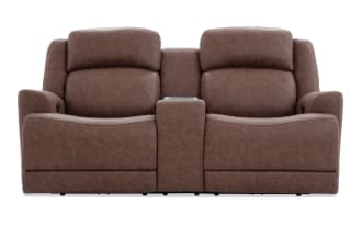 Brown leather reclining loveseat with center console and cup holders, featuring plush cushioning and modern design for home theater seating.