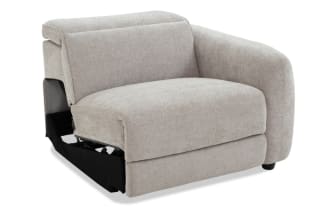 Modern beige fabric sectional sofa corner chair with plush cushions and rounded armrest, featuring textured upholstery and dark wooden legs.