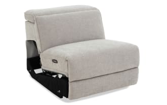 Modern beige fabric upholstered armless accent chair with cushioned seat and backrest, featuring a clean, minimalist design.