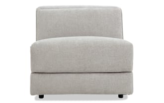 Modern armless accent chair upholstered in light gray textured fabric with a low backrest and cushioned seat, ideal for living room seating.