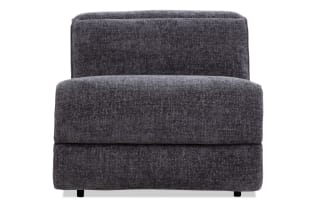 Dark gray upholstered armless accent chair with a textured fabric, cushioned seat and backrest, modern minimalist design.
