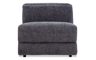 Modern armless accent chair upholstered in dark gray textured fabric with a thick cushioned seat and backrest, ideal for contemporary living spaces.