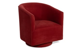 Red velvet swivel armchair with rounded back and cushioned seat, featuring a modern barrel design ideal for living room seating.