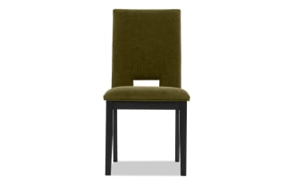 Upholstered dining chair with olive green fabric seat and backrest, black wooden legs, and a rectangular cutout detail on the back.