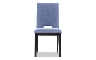 Modern dining chair with light blue upholstered fabric seat and backrest, featuring a small rectangular cutout and black wooden legs.
