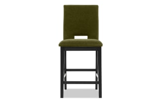 Upholstered bar stool with olive green fabric seat and backrest, black wooden legs, and footrest, modern dining seating.