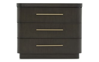Dark wood three-drawer nightstand with rounded edges and long horizontal brass handles, modern bedroom furniture design.