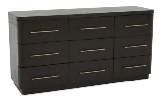 Dark wood dresser with nine drawers, featuring sleek brass handles and rounded edges, suitable for modern bedroom storage.