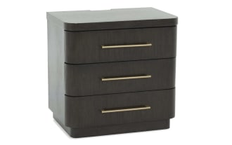 Dark wood three-drawer nightstand with rounded edges and sleek gold metal handles, suitable for modern bedroom storage.