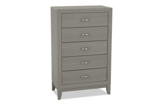Gray wooden chest of drawers with five metal handles, featuring a modern design and raised legs for bedroom storage.