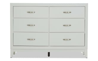 White wooden dresser with six drawers, brushed metal handles, and a modern, clean-lined design, ideal for bedroom storage.