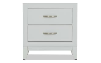 White wooden nightstand with two drawers, brushed metal handles, and a modern, clean-lined design.