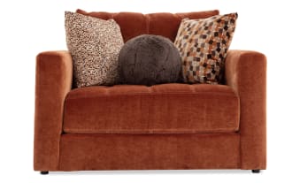Spice-colored Jewels Spice Side Chair in glam style with plush polyester fabric, thick seat cushion, and three decorative accent pillows.