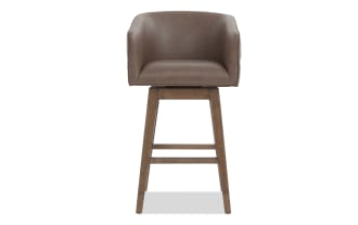 Brown leather swivel bar stool with cushioned seat and backrest, wooden legs, and footrest, ideal for kitchen or bar seating.
