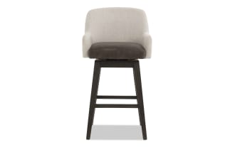 Swivel bar stool with beige fabric backrest, dark brown leather seat cushion, and dark wood tapered legs with footrest, modern style.