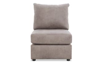 Armless accent chair with taupe microfiber upholstery, plush cushions, and low-profile black legs, ideal for modern living spaces.