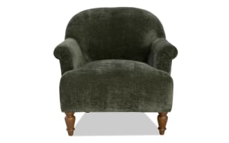 Dark green velvet armchair with rolled arms and wooden turned legs, featuring a plush, rounded back and cushioned seat for comfortable seating.