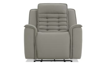Modern gray leather recliner chair with padded armrests, cushioned backrest, and stitched detailing, designed for comfort and relaxation.