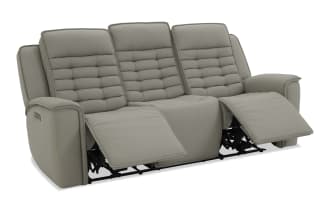 Gray leather reclining three-seater sofa with padded backrests and armrests, featuring horizontal stitching and cushioned footrests for comfort.
