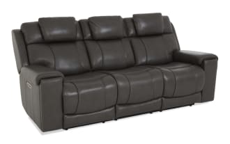 Dark gray leather reclining sofa with three seats, padded armrests, and cushioned headrests, designed for living room comfort.