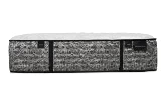 Mattress side view with a gray and black paisley pattern, white quilted top, and black trim. Labels read "PLUSH," "FIRM," and "DISTINCTION."