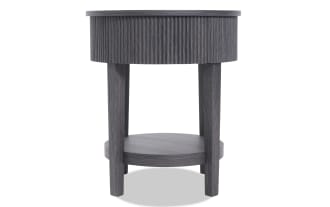 Round dark gray wooden side table with textured vertical grooves on the apron, four straight legs, and a lower circular shelf.