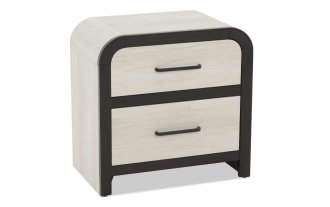 Two-drawer nightstand with light wood finish drawers and dark wood frame, featuring black metal handles and rounded top corners.
