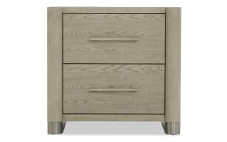 Two-drawer nightstand in light oak wood finish with brushed metal handles and rounded corners, featuring metal feet for modern bedroom storage.