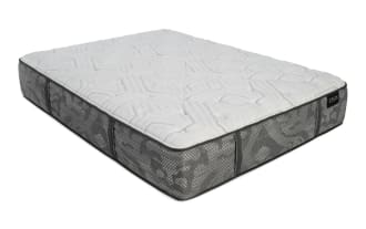 Zeus mattress side view showing gray patterned fabric with black handles and white quilted top, highlighting mattress thickness and design.