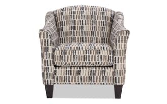 Upholstered armchair with a modern geometric pattern in beige, brown, and black tones, featuring cushioned seat and wooden legs.