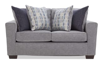 Gray fabric loveseat with two patterned blue and beige cushions and two solid dark blue cushions, featuring a modern design and wooden legs.