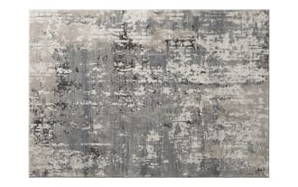 Contemporary area rug with an abstract distressed pattern in shades of gray, beige, and cream, featuring a soft, textured surface suitable for modern living spaces.