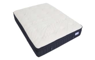 Crescent & Cloud mattress with plush white quilted top and dark navy blue sides featuring vertical stitching and fabric handles.