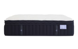 Crescent & Cloud mattress with plush white quilted top and dark navy blue sides featuring vertical stitching and fabric handles.