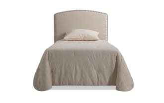 Beige transitional Isabella Twin Upholstered Panel Headboard with arched top, individual nailhead trim, and soft polyester fabric upholstery.