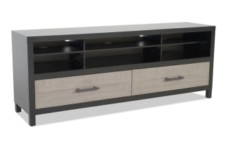 Black and beige wooden TV stand with two drawers, open shelves, cable management holes, and metal handles for media storage.