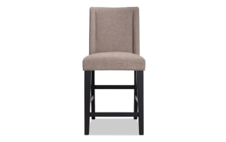Montana Black & Beige Rustic Counter Height Stool with beige polyester fabric upholstery, solid back, and rubberwood legs for dining spaces.