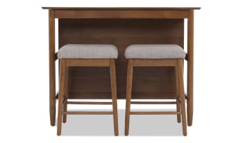 Mid-century modern wooden bar table with two matching cushioned stools featuring light gray fabric seats and tapered legs.