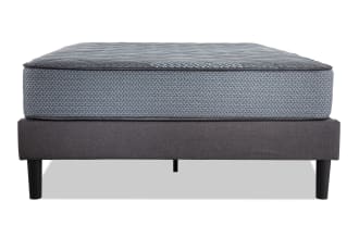 Synergy 10'' Twin XL Firm Universal Mattress Set with gray patterned top, dark gray upholstered foundation, and black tapered legs for firm support.
