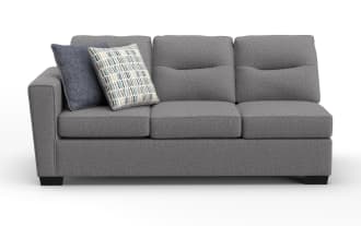 Modern gray fabric three-seater sofa with plush cushions and two decorative throw pillows, featuring a clean, contemporary design.