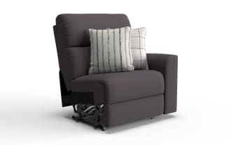 Modern dark gray fabric armchair with a single armrest on the right, featuring two decorative white pillows with striped and checkered patterns.
