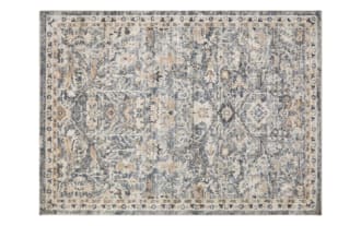 Giada 5' x 7' brown transitional Oriental rug featuring intricate vintage-inspired floral patterns in muted beige and gray tones, made of durable polyester fabric.