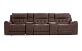 Brown leather reclining three-seat sofa with diamond tufted backrests, padded armrests, and built-in center console for living room seating.